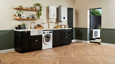 Utility room with gas boilers and an outdoor air source heat pump through the door