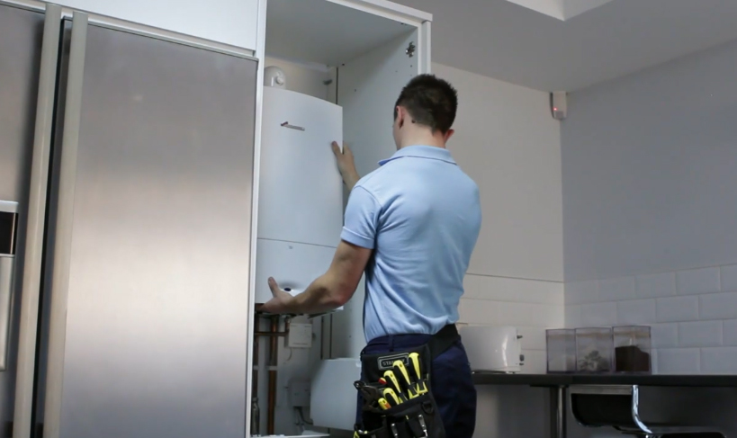 man installing boiler