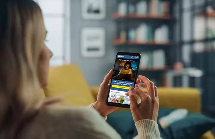 Woman using Swale Heating website on mobile phone