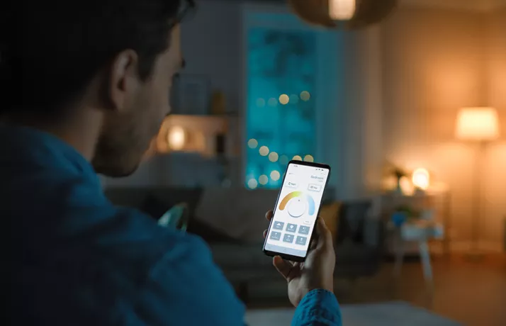 Man using central heating controls on mobile phone