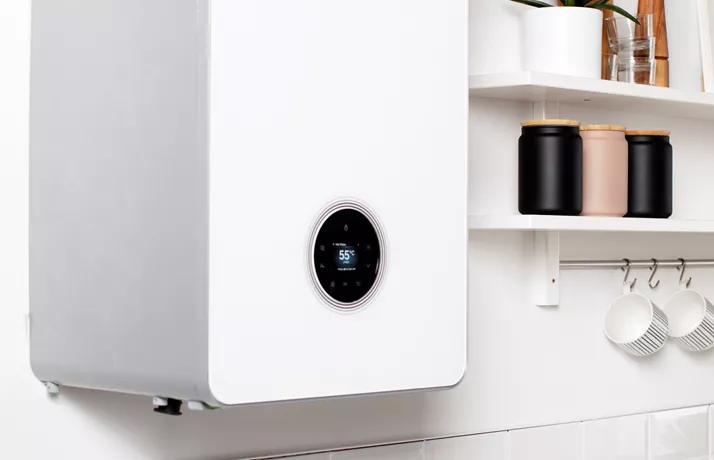 Boiler amongst kitchen cupboards with a thermostat display