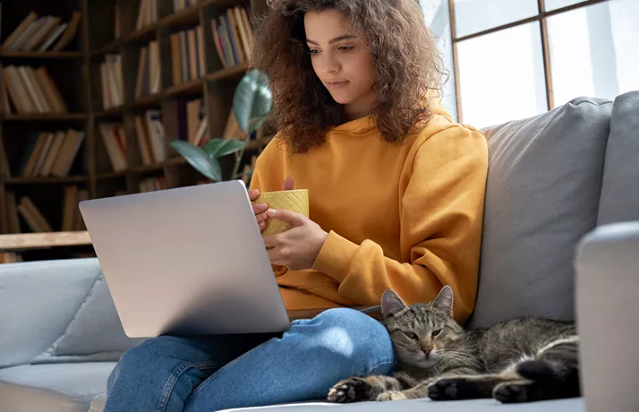 Lady and cat with laptop